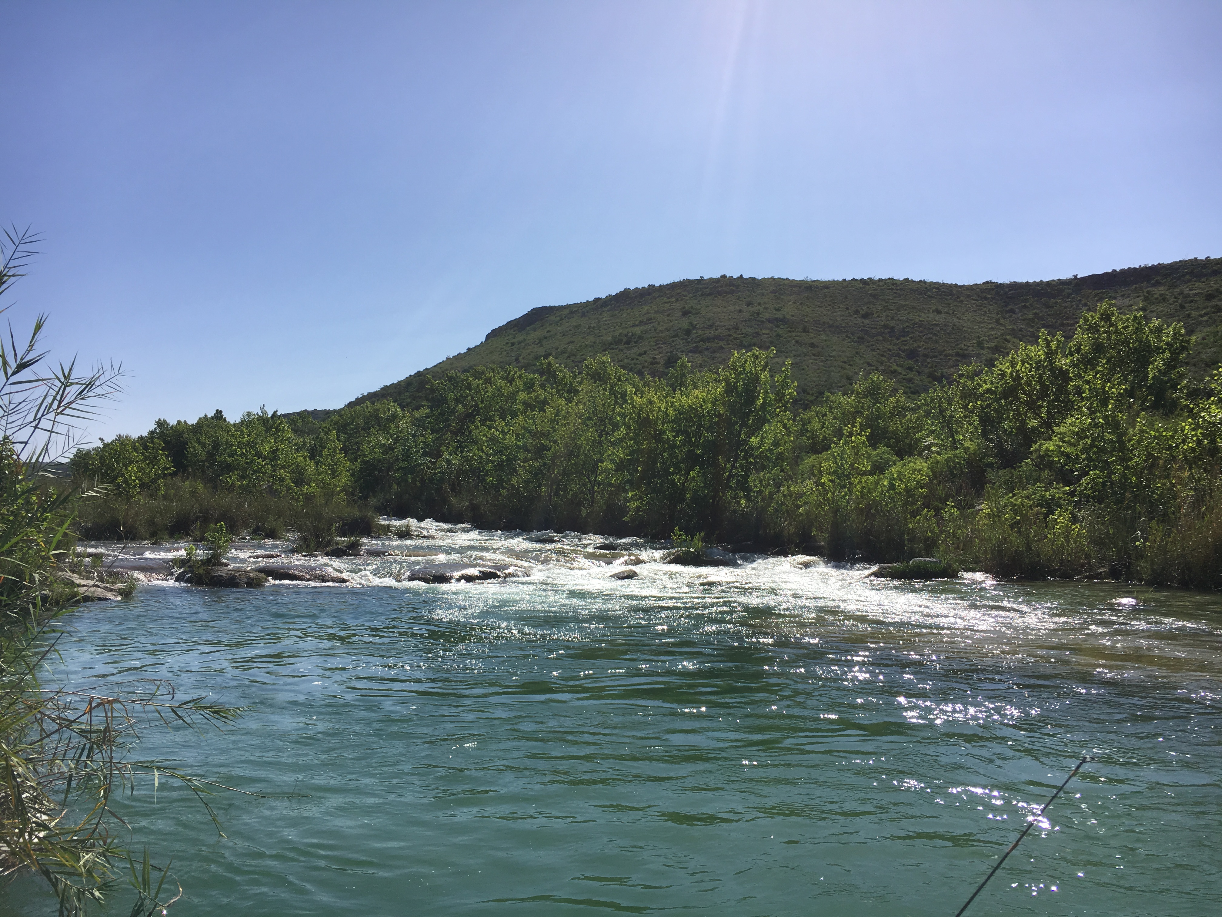 The rapids ahead — crystal clear turquoise water, Class I-II run leading to heavier water downstream