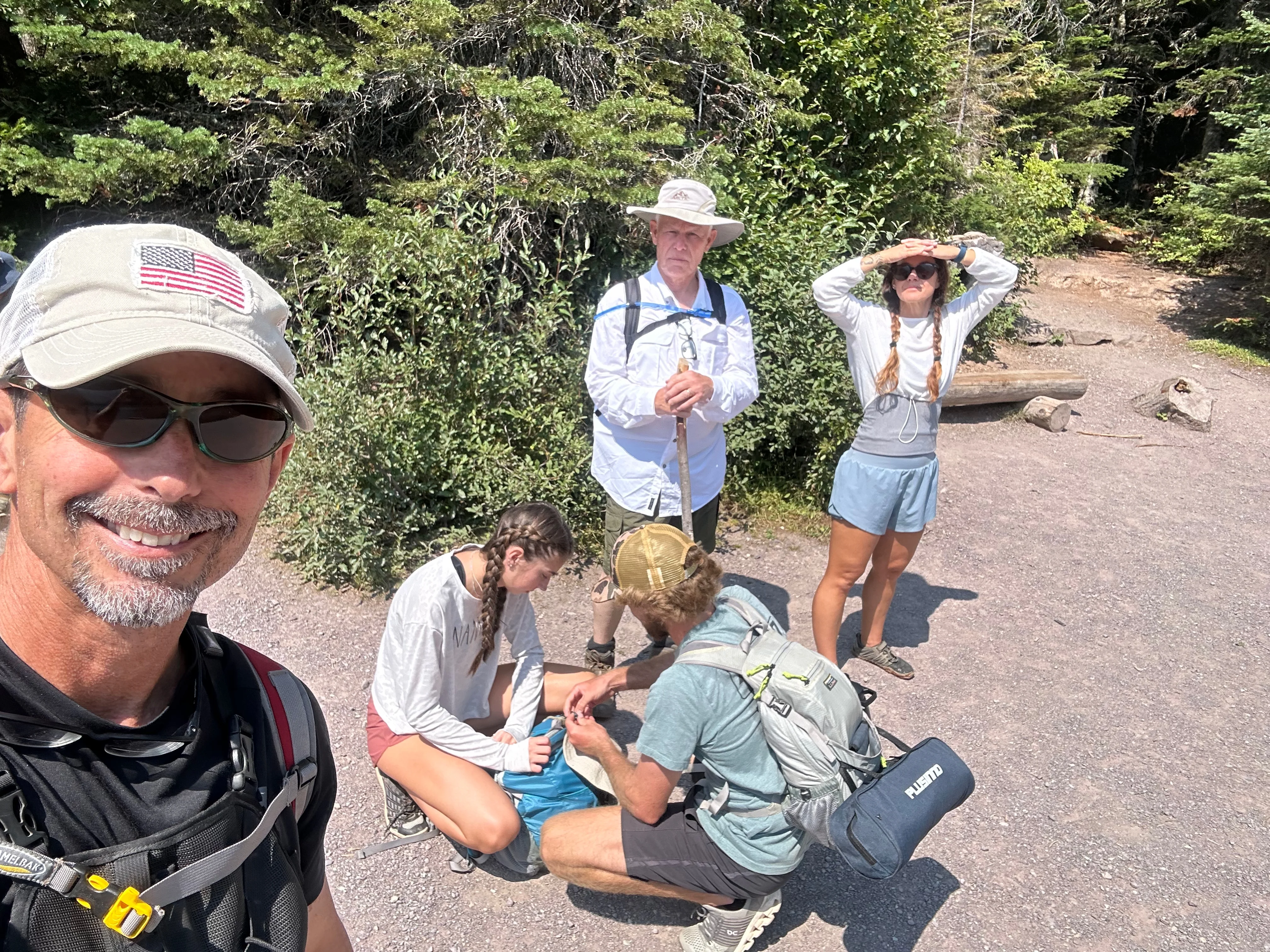 Family group at a trailhead in Glacier National Park before a hike