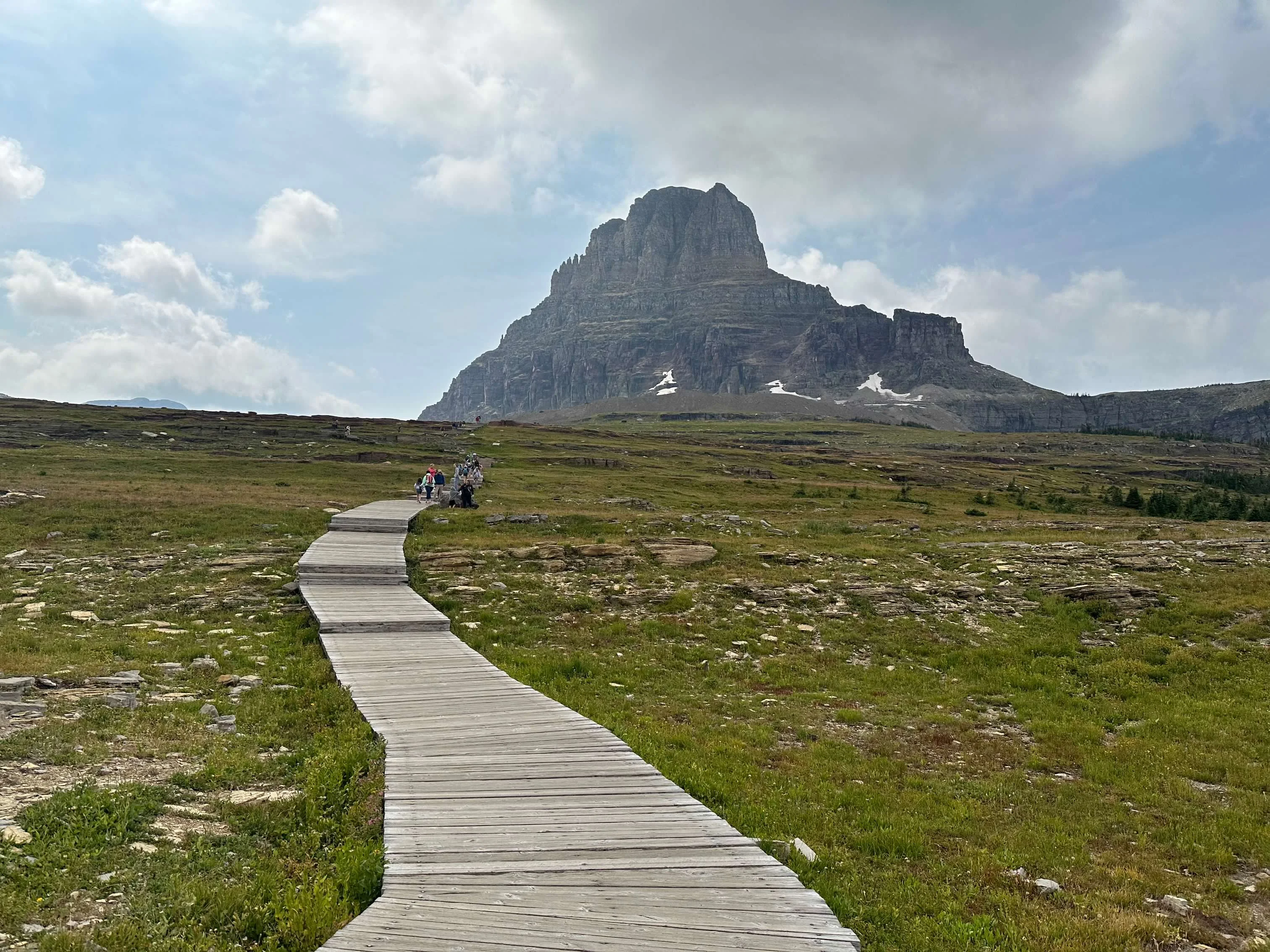 Crowded boardwalk trail leading toward Clements Mountain at Logan Pass, Glacier National Park