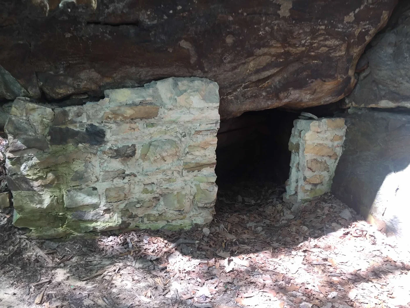An ancient structure tucked against the cliff face — approach trails lead you to things climbing guides don't mention