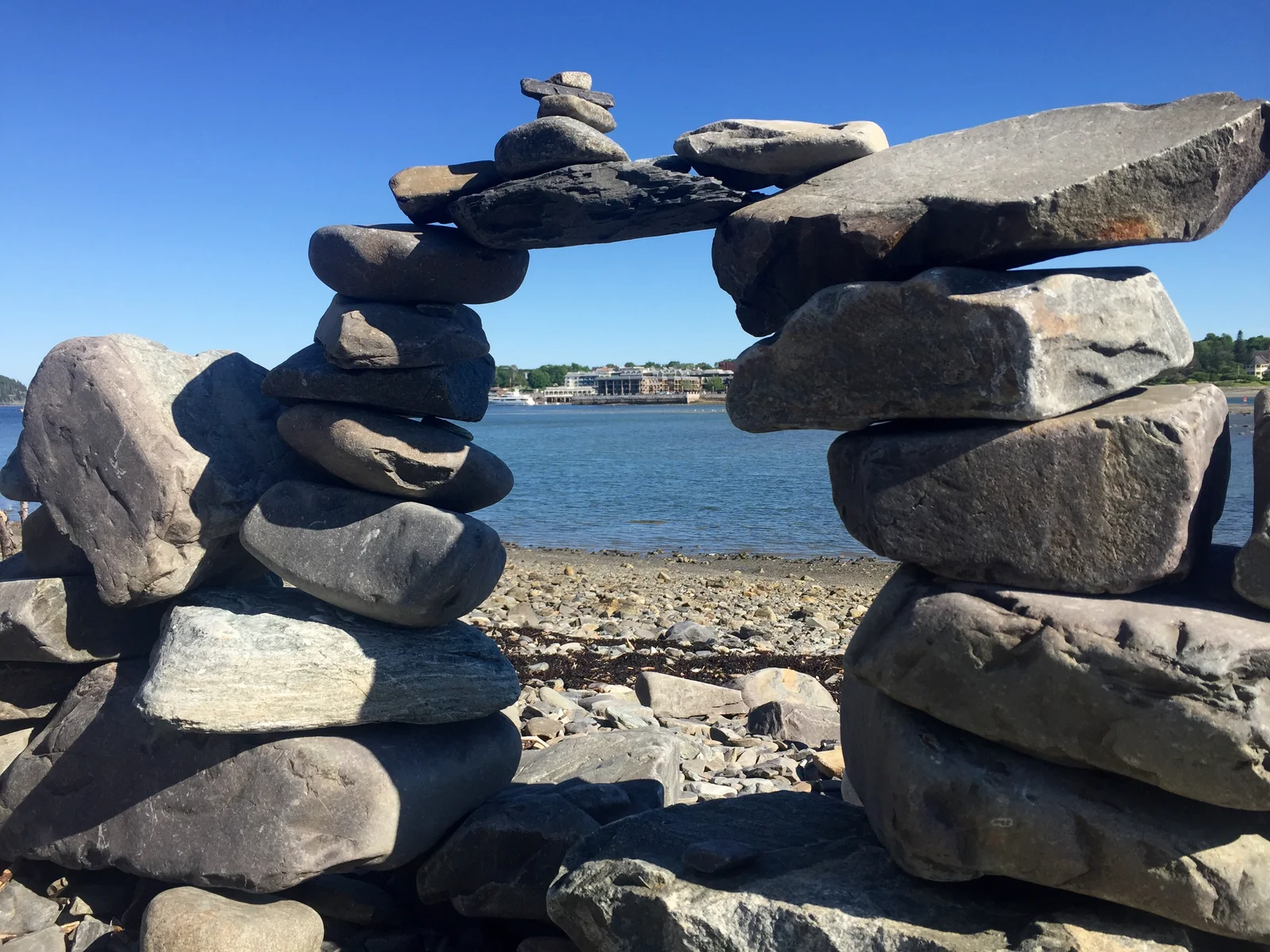 A view of Bar Harbor, Maine seen through a gap in coastal rock